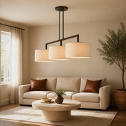 Living room | the pendant centered lengthwise above a round travertine coffee table