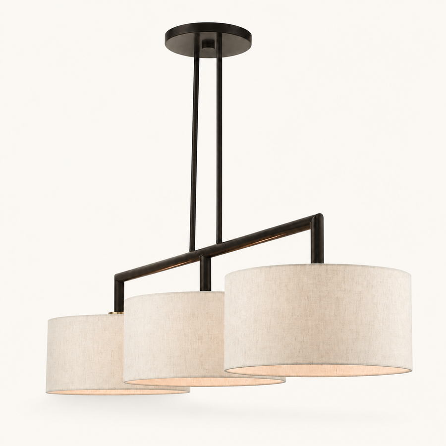Front | studio front of the three staggered oatmeal linen drums and bronze arm