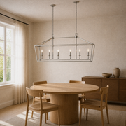 In a room | polished chrome 6-light linear chandelier over a round oak dining table in a warm ivory room