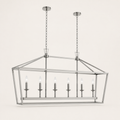 Studio | polished chrome 6-light linear chandelier from a low three-quarter studio angle showing cage depth and six candle bulbs