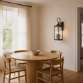Dining room angle | Three-quarter view of the antique bronze wall lantern beside the dining table