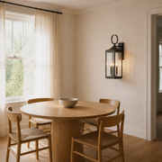 Dining room angle | Three-quarter view of the antique bronze wall lantern beside the dining table