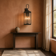Clay room | Antique bronze wall lantern on a clay wall above a dark console