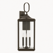 Front | Antique bronze aluminum wall lantern with oval loop, clear beveled glass, and three candle sockets