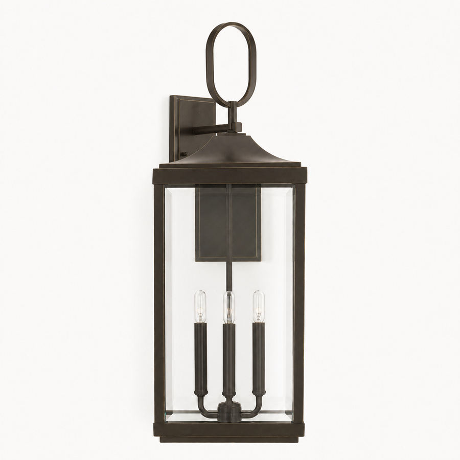 Front | Antique bronze aluminum wall lantern with oval loop, clear beveled glass, and three candle sockets