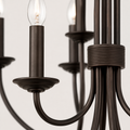 Close detail | dark bronze steel candle sleeve, bobeche, curved arm, and ribbed center band