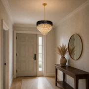 In a room | black and gold crystal chandelier in an entryway with a console table