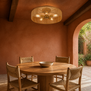 Terracotta dining room | natural rope drum flush mount beneath dark ceiling beams