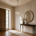 In a room | the pendant in a greige entryway beside an antique-brass mirror and console table