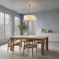 Sunroom | off-white linen-blend drum chandelier above a light-oak table in a cool blue-gray room