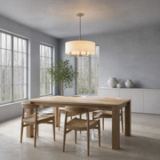 Sunroom | off-white linen-blend drum chandelier above a light-oak table in a cool blue-gray room