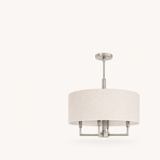 Studio | elevated three-quarter view of the off-white drum, round canopy, rigid downrod, and brushed nickel arms