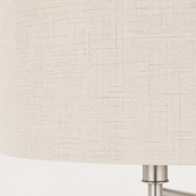 Close view | fine cross-hatch weave on the off-white linen-blend drum shade with a brushed nickel arm edge