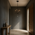 Entryway | English Bronze globe chandelier hanging in a dark blue-grey entry