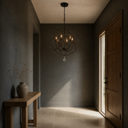 Entryway | English Bronze globe chandelier hanging in a dark blue-grey entry