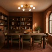 In a room | brushed brass six-globe semi-flush fixture in a terracotta library dining room