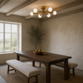In a room | brushed brass six-globe semi-flush fixture in a cool limewash dining room beneath exposed beams