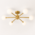 Studio | brushed brass six-globe semi-flush fixture from an elevated three-quarter studio angle