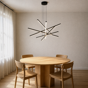 In a warm dining room | matte black six-bar integrated LED chandelier above a pale oak round table