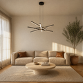 In a living room | matte black six-bar integrated LED chandelier above a round coffee table