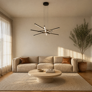 In a living room | matte black six-bar integrated LED chandelier above a round coffee table