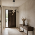 In an entryway | matte black six-bar integrated LED chandelier beside a tall sidelight
