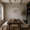 Dining room | Brushed nickel four-light globe chandelier above a dark walnut table