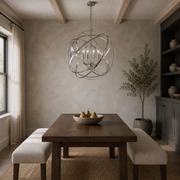 Dining room | Brushed nickel four-light globe chandelier above a dark walnut table