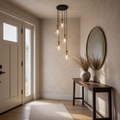 In a room | the cluster pendant lighting a console table in the entryway