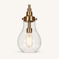 Detail | close view of one teardrop glass, brass socket, and filament bulb
