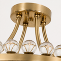 Hardware detail | close view of antique brass canopy, rod junctions, fasteners, and crystal sphere row