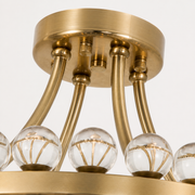 Hardware detail | close view of antique brass canopy, rod junctions, fasteners, and crystal sphere row