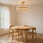 Dining room angle | lower view of antique brass ring fixture over a round wood table