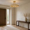 Entryway | antique brass semi-flush mount above a dark wood console in a limewash entry