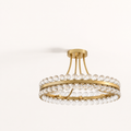 Studio three-quarter | antique brass ring, round canopy, curved rods, brass bands, and clear crystal spheres