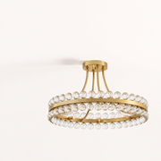 Studio three-quarter | antique brass ring, round canopy, curved rods, brass bands, and clear crystal spheres