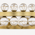 Crystal detail | close view of clear crystal spheres, brass support lines, and ring band