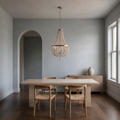 Scale | weathered white wood-bead chandelier beside a full-height window and arched doorway for scale