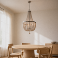 Angle | low-angle view of the weathered white wood-bead chandelier over a pale oak dining table
