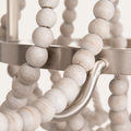 Texture | close view of weathered white wood bead grain and the brushed-steel curved arm