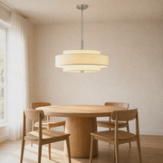 Dining room | off-white three-drum linen-blend chandelier over a round pale-oak table