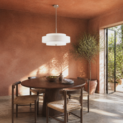 Terracotta room | off-white three-drum linen-blend chandelier over a round dark-wood table