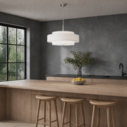 Kitchen island | off-white three-drum chandelier above a wood island in a dark-gray kitchen