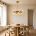 Scale | warm gold-tone 12-light crystal ring chandelier beside an uncropped full-height doorway