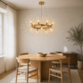 In a room | warm gold-tone 12-light crystal ring chandelier over a pale oak dining table