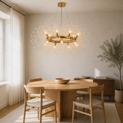 In a room | warm gold-tone 12-light crystal ring chandelier over a pale oak dining table
