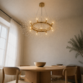 Angle | warm gold-tone 12-light crystal ring chandelier from a low corner angle over a dining table