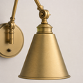 Texture detail | close view of brushed warm brass metal on the conical shade, raised neck rings, and upper joint