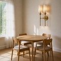 Dining room angle | three-quarter view of the two-light wall sconce in the oak dining room