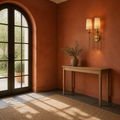 Terracotta room | two-light rubbed brass wall sconce beside a console